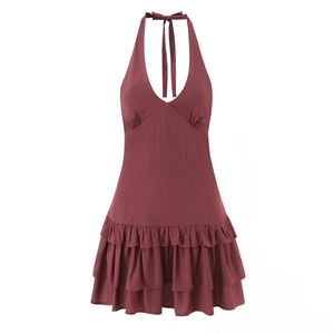 Detail view of burgundy halter neck dress featuring layered ruffle hem and deep V-neck design