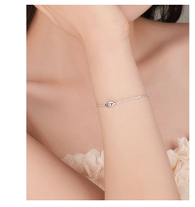 Detailed close-up of s925 silver Evil Eye bracelet with zircon inlay on model wrist