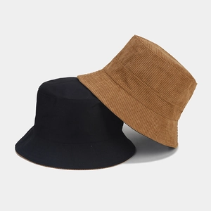 Dual-color corduroy bucket hats in black and caramel brown with soft ribbed texture