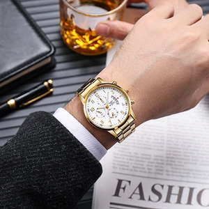 Men's gold multifunctional quartz business watch with white dial on a wrist