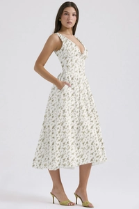 Detail view of V-neck floral midi dress showing the green botanical print and side pocket
