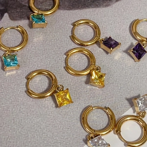 Close-up of square zircon drop earrings in various colors with 18k gold plated finish