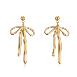 Detailed view of elegant gold bow ribbon earrings with a polished metallic finish