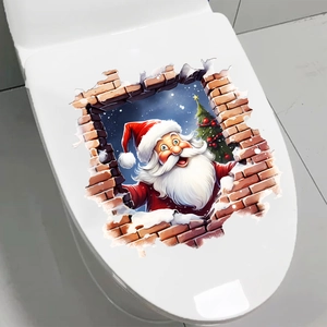 3D Christmas Santa wall sticker showing through a broken wall on a white toilet seat lid