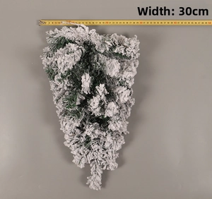 Detail of flocked Christmas tree branch with white snow coating and 30cm width scale