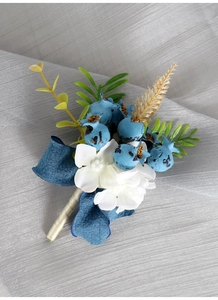 Detail of groom boutonniere with blue berries, white flowers and navy silk ribbon