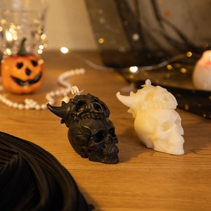 Detailed view of skull candles in black and white set on a festive Halloween table