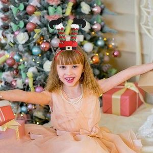 Festive Christmas headband featuring elf legs design for holiday party costumes and decor