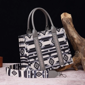 Close-up of bohemian tote bag with geometric print on a grey textured surface