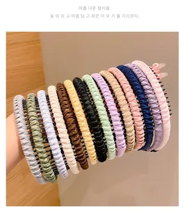 Detail showing various colors of pleated fabric headbands with non-slip plastic teeth