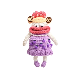 Handmade crochet doll bag with red big lips and purple dress on white background