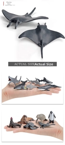 Macro detail of realistic mini marine animal toys showing manta ray and actual scale on palm