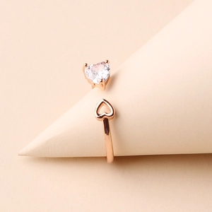 Macro detail of rose gold heart ring with large white zircon and openwork heart design