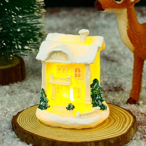 Close-up of glowing resin City Hall miniature house with festive Christmas decor