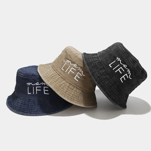 Close-up of three washed cotton bucket hats featuring detailed white embroidery text