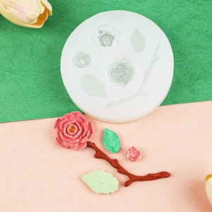 Detail of rose and leaf silicone mold showing the white flexible texture and floral patterns