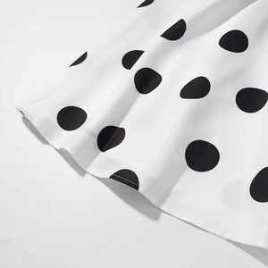 Détail du tissu blanc élégant à grands pois noirs avec couture d'ourlet fine