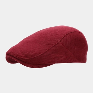 Detail showing the burgundy knit texture and reinforced brim of this vintage newsboy cap