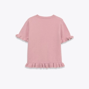 Macro view of ribbed crew neck and ruffle trim on pink short sleeve knitted top