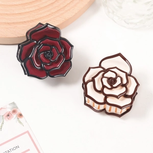 Elegant sweet rose hair clips in red and cream resin, set of two on white background