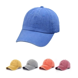 Close-up of vintage washed cotton baseball caps in blue, yellow, grey and orange colors