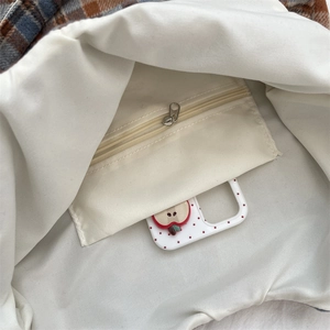 Detailed interior of vintage plaid tote bag featuring a practical zipper pocket and cotton lining