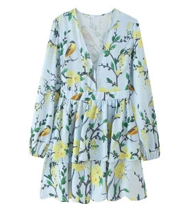 Detail of V-neck printed mini dress featuring yellow floral patterns and long puff sleeves