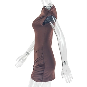 Detail of side ruching and shoulder knot cutout on a slim fit dark brown mini dress