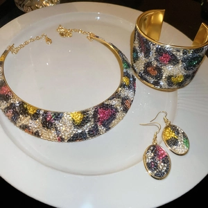 Detailed view of gold metal jewelry set with leopard pattern multi-color rhinestones