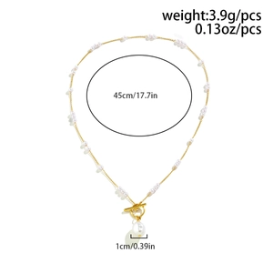 Detailed view of a gold chain with faux pearls and an irregular pearl pendant with OT clasp