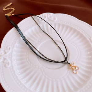 Double-layer necklace with black leather cord, metal chain, and zircon cherry pendant