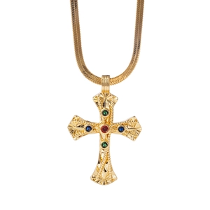 Gold flat snake chain necklace with colorful zircon cross pendant on white background