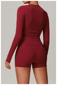 Detail view of burgundy long sleeve yoga set featuring high-waisted shorts and soft brushed fabric