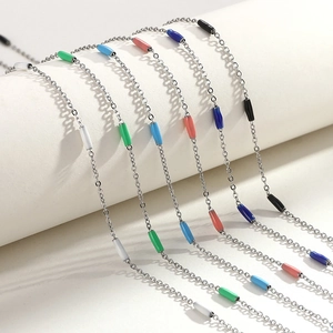 Detailed shot of multi-color enamel bead necklaces and bracelets in titanium steel
