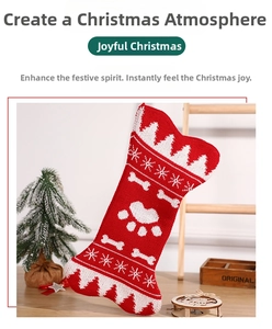 Detail of red and white knit bone-shaped Christmas stocking with snowflake and paw patterns