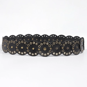 Detail of vintage black disc waist belt featuring retro punk rivets and brass metal eyelets