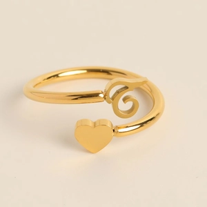 Detailed view of golden heart and scroll motif on the adjustable open band ring