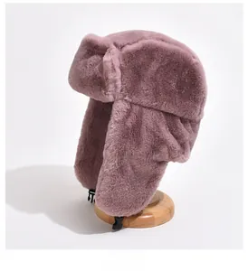 Close-up of mauve plush trapper hat with thick faux fur and buckle closure
