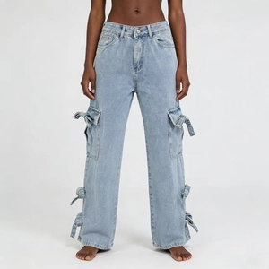 Detail view of light blue wide-leg cargo jeans with decorative bow accents and side pockets