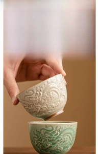Detailed relief dragon pattern on off-white and green ceramic kung fu tea cups