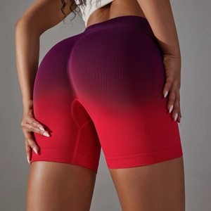 Macro view of seamless high waist shorts showing purple-to-red gradient fabric and ribbing