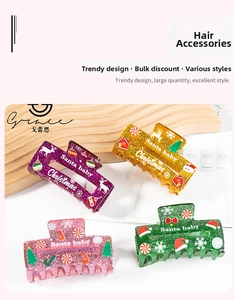 Detailed view of colorful Christmas hair claws with festive patterns and glitter finish