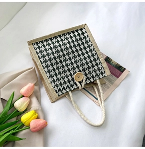 Detail of green houndstooth canvas tote bag with jute trim and wooden buckle closure