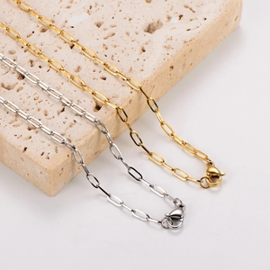 Minimalist gold and silver square link chain necklaces with lobster clasps on stone