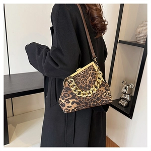 Detail of leopard print crossbody bag with vintage clasp and chunky gold chain strap