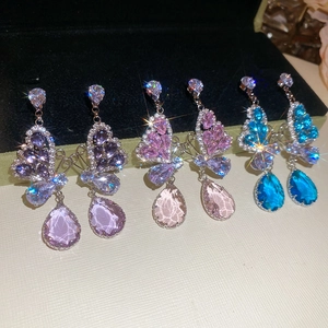 Detail of butterfly drop earrings featuring vibrant purple pink and blue zircon stones