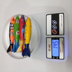 Weight measurement of four colorful diving torpedo toys on a digital scale