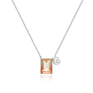 Detail of necklace with rectangular orange gemstone and white pearl on silver chain