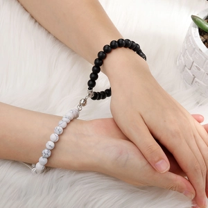 Close-up of magnetic connection between black matte and white marble stone bracelets