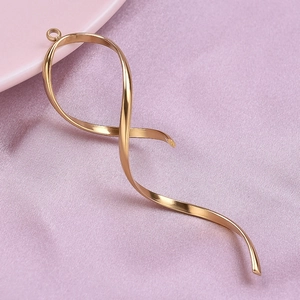 Macro shot of 304 stainless steel twisted ribbon pendant on pink silk background